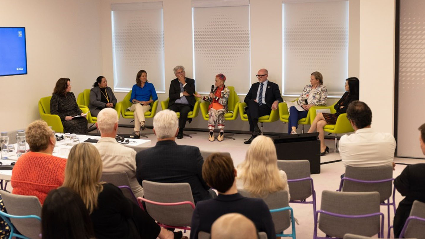 Attendees at the generalized pustular psoriasis (GPP) Forum watching panelists including those living with GPP, health care professionals, and experts discuss GPP