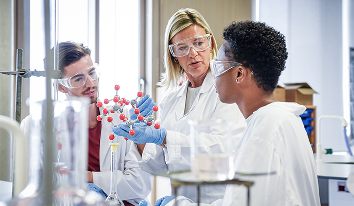 Three scientists working together in a lab