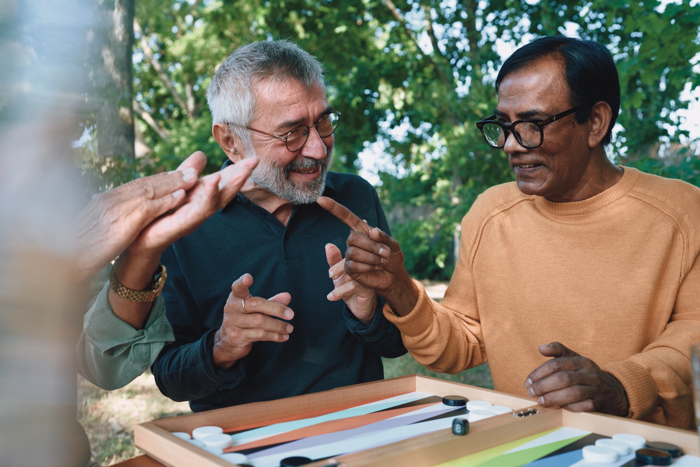 Two men wearing glasses playing board game